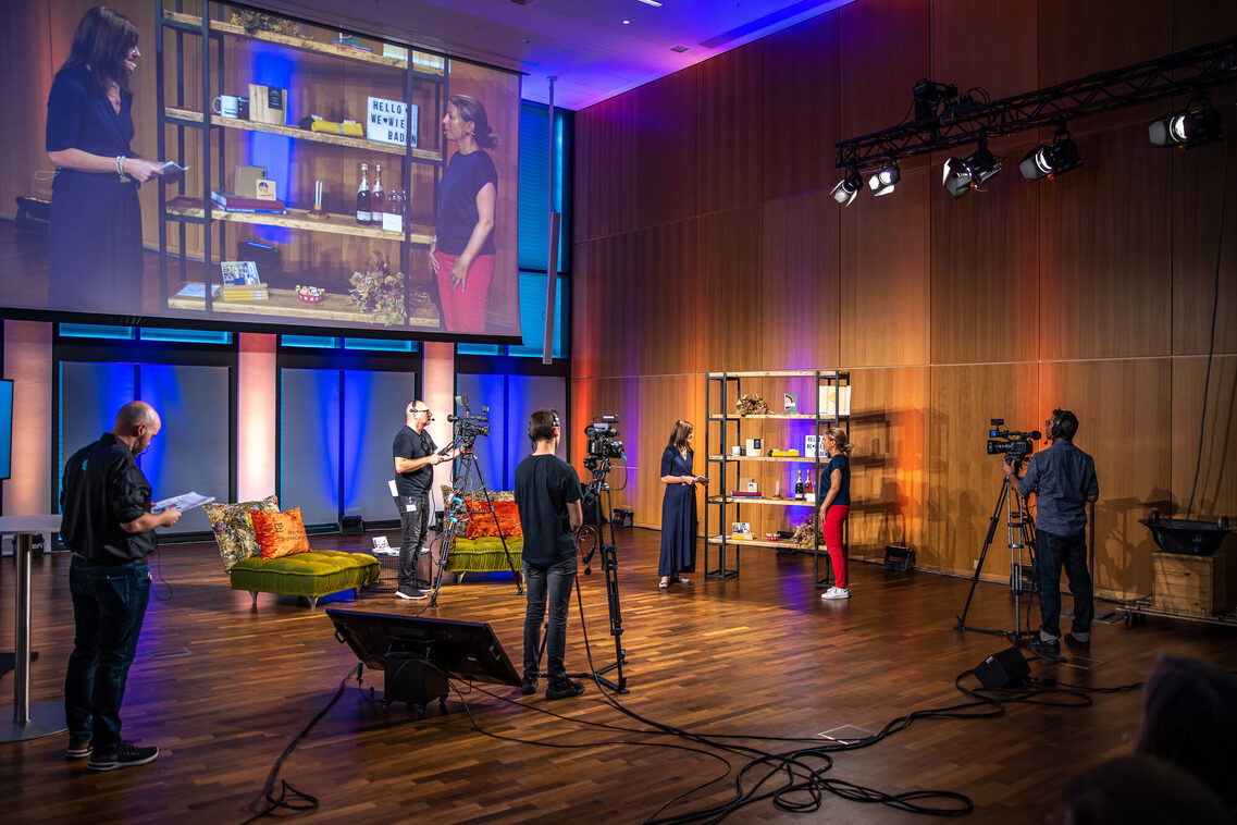 Zwei Frauen stehen vor einem Regal und sprechen